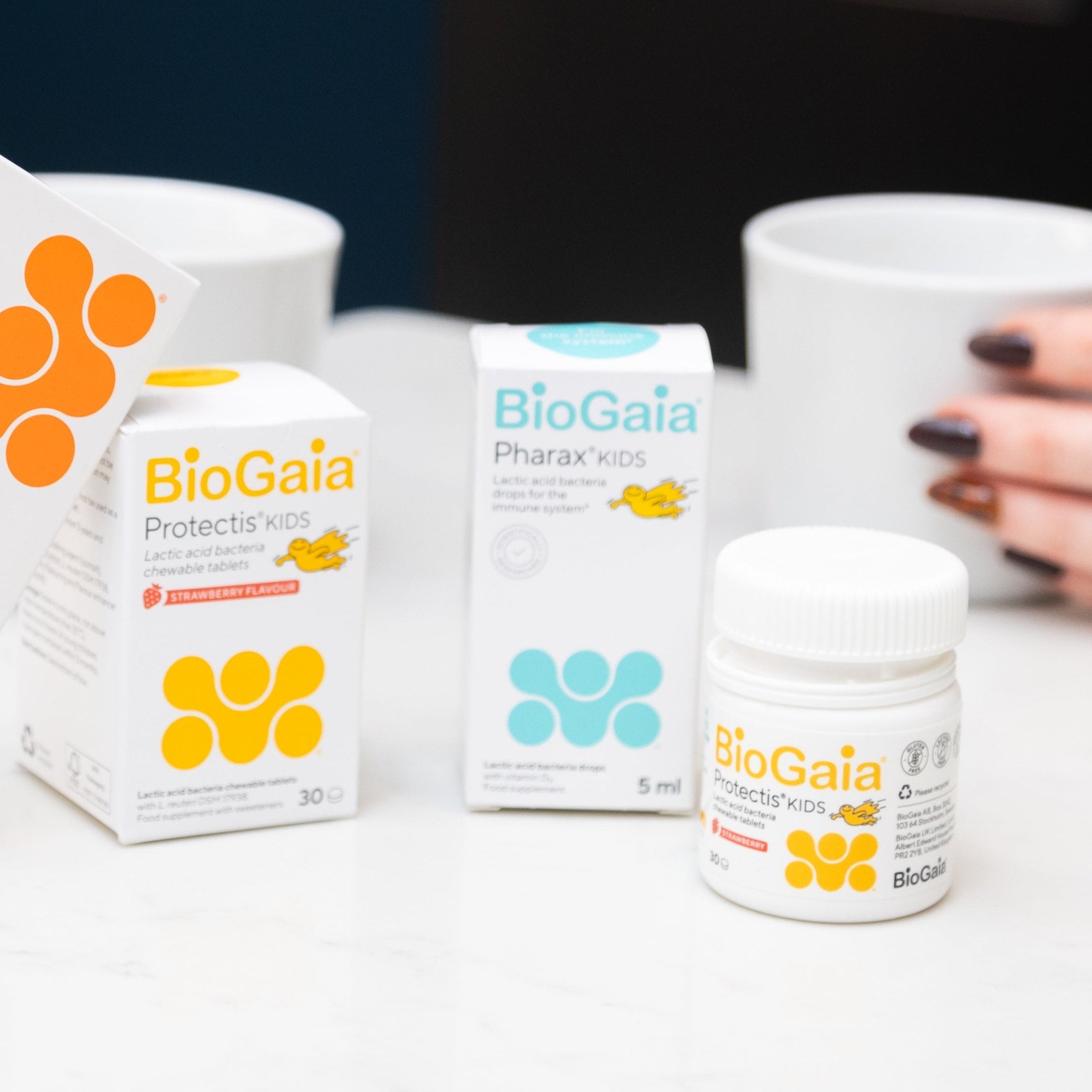 BioGaia children's health products on a white surface with a blurred background