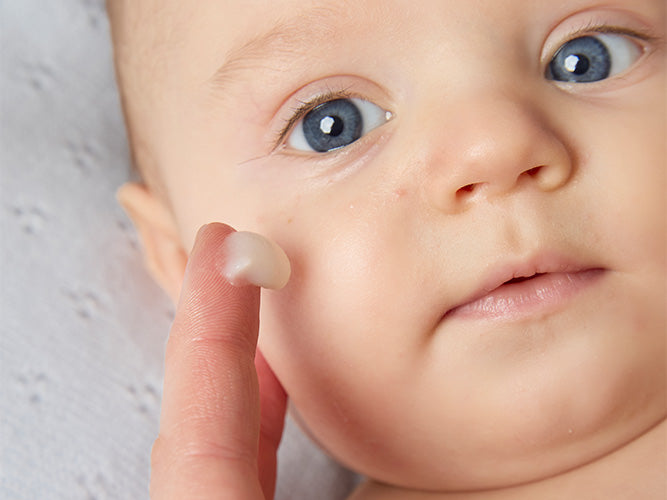 Mom applying BioGaia Probiotic Ointment  to baby's cheek. Ointment with live probiotics for babies and children with dry, sensitive and atopic-prone skin.