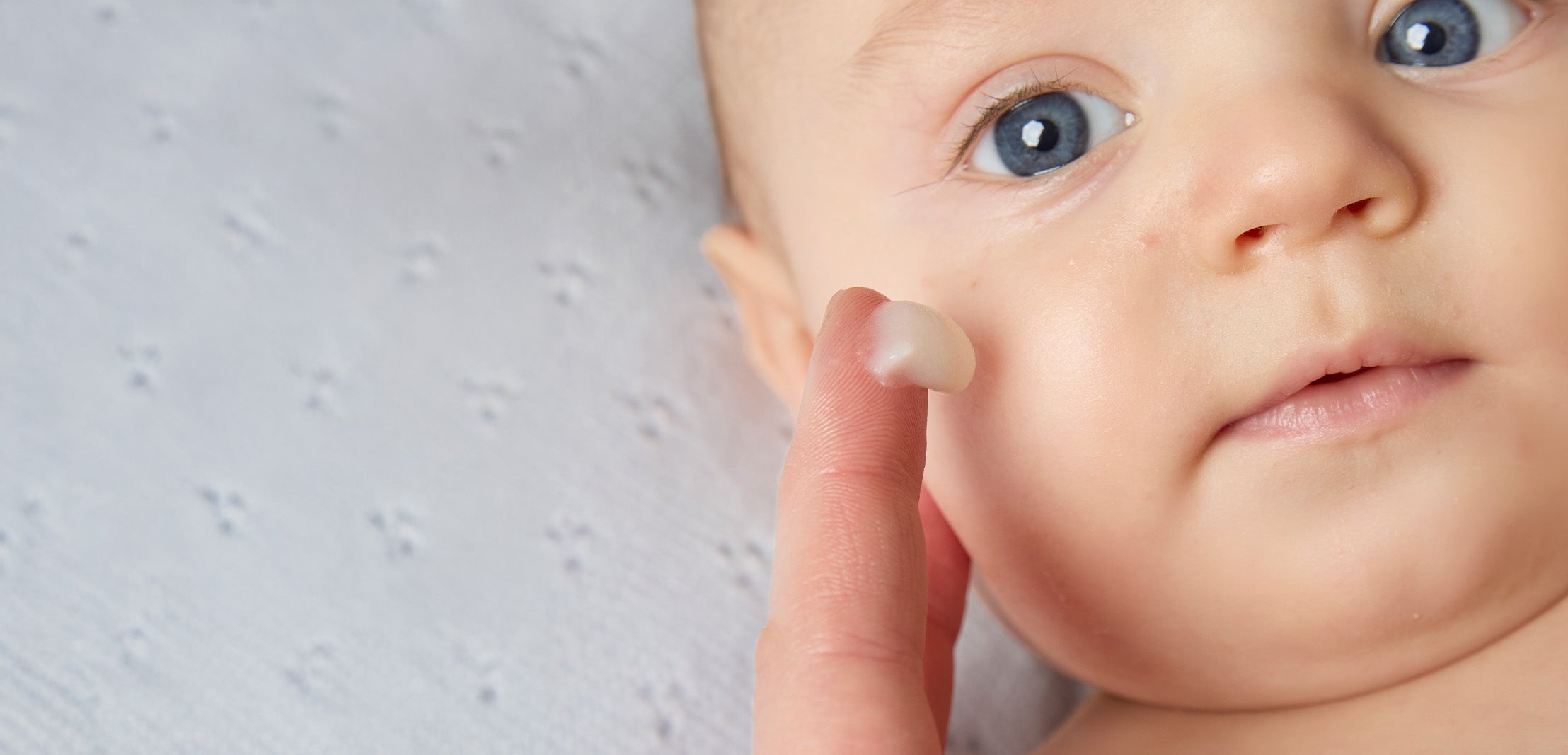 Mom applying BioGaia Probiotic Ointment  to baby's cheek. Ointment with live probiotics for babies and children with dry, sensitive and atopic-prone skin.