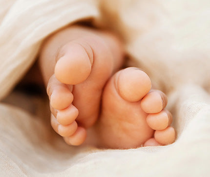 Close-up of a baby's feet wrapped in soft fabric