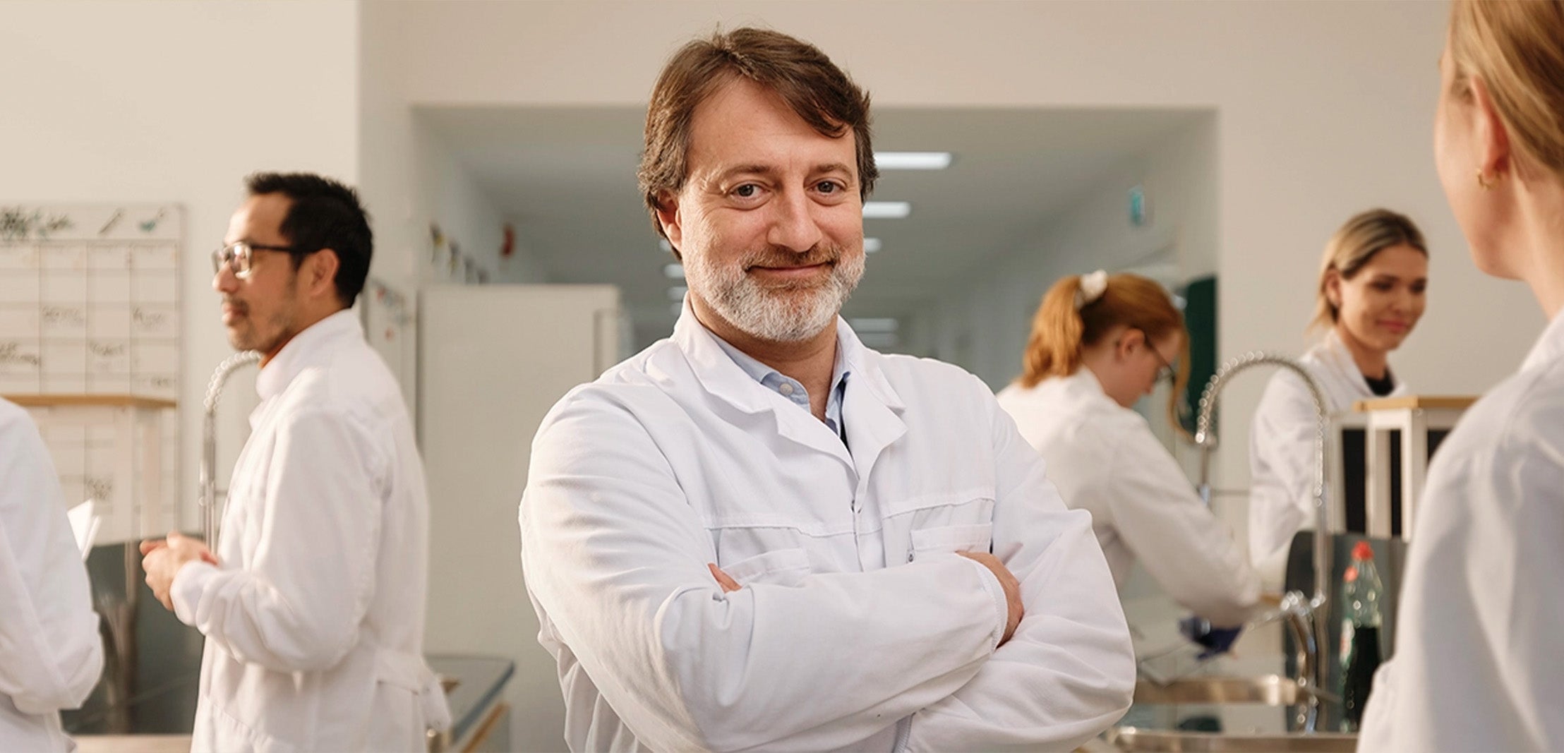 BioGaia scientists in a laboratory setting with one smiling at the camera. 