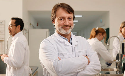 BioGaia scientists in a laboratory setting with one smiling at the camera. 